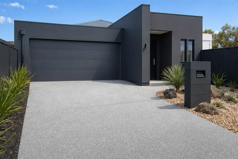 New concrete driveway outside charcoal garage